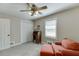 Bedroom featuring a comfy chair, desk, window, and double door closet at 2222 Ivy Crest Dr, Buford, GA 30519