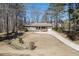 View of the home's front exterior, showcasing the lawn, driveway, and mature trees at 2222 Ivy Crest Dr, Buford, GA 30519