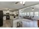 Modern kitchen with granite countertops, white cabinets, and black appliances open to sunroom at 2222 Ivy Crest Dr, Buford, GA 30519