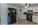 Spacious kitchen showcasing black appliances, white cabinets, and wood-look flooring at 2222 Ivy Crest Dr, Buford, GA 30519