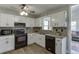 Well-lit kitchen with white cabinets, granite countertops, and black appliances at 2222 Ivy Crest Dr, Buford, GA 30519