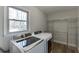 Functional laundry room with modern washer/dryer and storage shelving at 2222 Ivy Crest Dr, Buford, GA 30519