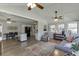 Bright sunroom open to kitchen featuring vaulted ceilings and wood-look flooring at 2222 Ivy Crest Dr, Buford, GA 30519