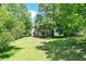 View of the home's backyard and patio surrounded by trees and foliage at 4110 Ridgebrook Bnd, Cumming, GA 30028