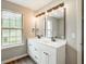 Bathroom features a double sink vanity, large mirrors, and a window at 4110 Ridgebrook Bnd, Cumming, GA 30028