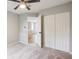 Bedroom with neutral carpet and double doors to closet, and an open door to hallway at 4110 Ridgebrook Bnd, Cumming, GA 30028