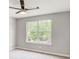 Bedroom featuring neutral walls, carpet, ceiling fan and a sun-filled window at 4110 Ridgebrook Bnd, Cumming, GA 30028