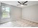 Bright, carpeted bedroom with a large window and ceiling fan offers a calm, relaxing space at 4110 Ridgebrook Bnd, Cumming, GA 30028