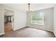 Bright dining room features a modern chandelier, large window, and wood-look flooring at 4110 Ridgebrook Bnd, Cumming, GA 30028