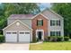 Charming two-story home with a well-manicured lawn and an attached two-car garage at 4110 Ridgebrook Bnd, Cumming, GA 30028