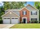 Charming two-story home with a well-manicured lawn and an attached two-car garage at 4110 Ridgebrook Bnd, Cumming, GA 30028