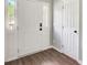 Bright foyer featuring a white front door with sidelights and durable wood-look flooring at 4110 Ridgebrook Bnd, Cumming, GA 30028