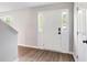 Bright foyer featuring a white front door with sidelights and durable wood-look flooring at 4110 Ridgebrook Bnd, Cumming, GA 30028