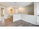 Bright hallway featuring hardwood-style flooring and a view of the bathroom at 4110 Ridgebrook Bnd, Cumming, GA 30028