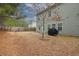 Large, fenced backyard with a patio area and mature trees at 981 Sonoma Dr, Lawrenceville, GA 30045