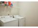 Well-equipped laundry room features modern washer and dryer and storage shelving at 981 Sonoma Dr, Lawrenceville, GA 30045