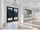 Elegant living room with coffered ceilings, modern light fixtures, and large windows at 986 Carl Sanders Dr, Acworth, GA 30101