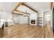 Bright living room with wooden beams, fireplace, built-in shelves and light hardwood flooring at 986 Carl Sanders Dr, Acworth, GA 30101