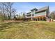 Wide backyard with a multi-story home featuring green siding and brick base and a playhouse at 1865 Butlers Ln, Decatur, GA 30033