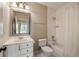 Well-lit bathroom featuring a shower-tub combo and vanity with stylish fixtures and a decorative mirror at 1865 Butlers Ln, Decatur, GA 30033