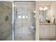 Elegant bathroom with glass-enclosed tiled shower and vanity with sink at 1865 Butlers Ln, Decatur, GA 30033