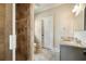 A bathroom featuring a glass-door shower and gray vanity with granite counters at 1865 Butlers Ln, Decatur, GA 30033