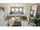 Relaxing bathroom showcasing tiled tub, a standing mirror and natural light at 1865 Butlers Ln, Decatur, GA 30033