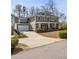 View of the house from the side showcasing the garage, driveway, and surrounding landscaping at 1865 Butlers Ln, Decatur, GA 30033