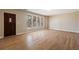 A spacious living room with hardwood floors and a dark wood front door and window frames at 1865 Butlers Ln, Decatur, GA 30033