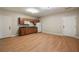 Bright living room featuring wood floors, a kitchenette, and two access doors at 1865 Butlers Ln, Decatur, GA 30033