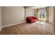 A living room featuring hardwood floors and a red sofa next to a window at 1865 Butlers Ln, Decatur, GA 30033