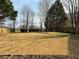 Expansive backyard with mature trees and a fenced perimeter at 2585 Kirkstone Dr, Buford, GA 30519