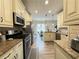 Bright eat-in kitchen featuring granite countertops, stainless steel appliances, and decorative pendant lighting at 2585 Kirkstone Dr, Buford, GA 30519