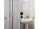 Small bathroom with a pedestal sink, mirror, and towel rack at 2939 Greyhawk Ln, Cumming, GA 30040