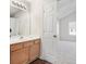 Bathroom with light wood cabinets, large mirror, and an adjoining bedroom at 2939 Greyhawk Ln, Cumming, GA 30040