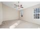 Spacious bedroom with a vaulted ceiling, carpeted floor, and a ceiling fan with light fixture at 2939 Greyhawk Ln, Cumming, GA 30040