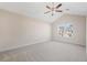 Bedroom with vaulted ceiling, carpet, ceiling fan, and large window at 2939 Greyhawk Ln, Cumming, GA 30040