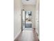 Hallway with wood floors featuring a view of exterior and a door on the right at 2939 Greyhawk Ln, Cumming, GA 30040