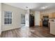 Bright kitchen with wood cabinets, black appliances, and an open door leading to an outdoor patio at 2939 Greyhawk Ln, Cumming, GA 30040