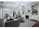 Inviting living room features a fireplace, built-in shelves, and seamless flow to the dining area and kitchen at 2939 Greyhawk Ln, Cumming, GA 30040