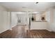 Open-concept living room with hardwood floors, neutral paint, and view to kitchen at 2939 Greyhawk Ln, Cumming, GA 30040