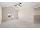 Bright main bedroom featuring ceiling fan, carpet, vaulted ceilings, and natural light at 2939 Greyhawk Ln, Cumming, GA 30040