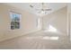 Bright main bedroom with ample windows, carpet, and a ceiling fan at 2939 Greyhawk Ln, Cumming, GA 30040