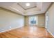 Bedroom with hardwood floors, tray ceiling, and large window at 4170 Hopkins Bluff Way, Duluth, GA 30096