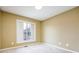 A bedroom with neutral colored walls with carpet and a double-hung window at 4170 Hopkins Bluff Way, Duluth, GA 30096