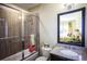 Well-lit bathroom featuring a shower with glass doors, granite vanity, and decorative mirror with views of a bedroom at 4987 Kyle Dr, Powder Springs, GA 30127