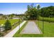 A well-maintained bocce ball court with a sand surface, manicured lawn, and a paver path at 4987 Kyle Dr, Powder Springs, GA 30127