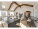 Island in bright community room featuring shiplap walls, a high ceiling with exposed beams, and abundant seating at 4987 Kyle Dr, Powder Springs, GA 30127