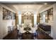 Formal dining room featuring elegant wallpaper, a grand chandelier, and a stylish buffet at 4987 Kyle Dr, Powder Springs, GA 30127