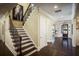 Elegant foyer featuring hardwood floors, a staircase with iron railings, and recessed lighting at 4987 Kyle Dr, Powder Springs, GA 30127